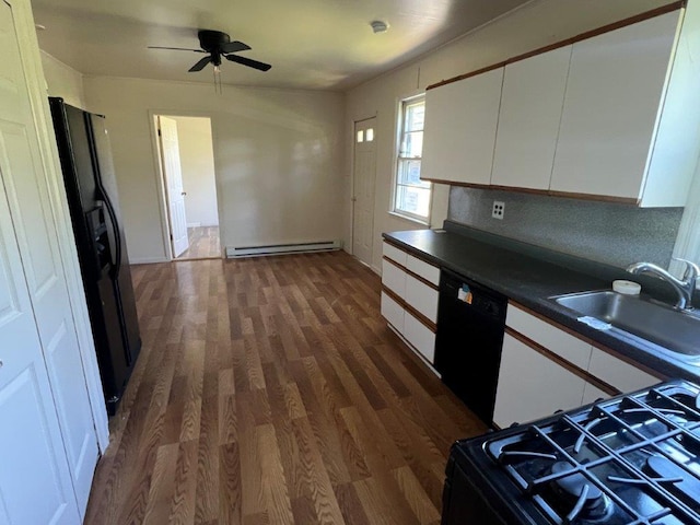 29 Purse Ln, Fishkill, NY 12533 - kitchen with black appliances, a baseboard radiator, a sink, dark wood-style floors, and white cabinetry