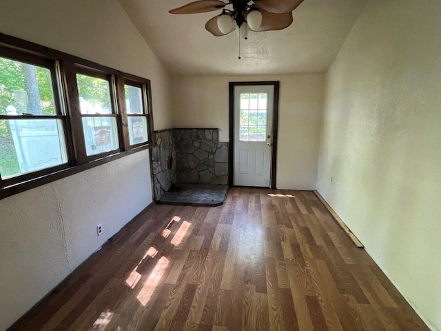 29 Purse Ln, Fishkill, NY 12533 - empty room with wood finished floors, lofted ceiling, ceiling fan, a textured wall, and a fireplace