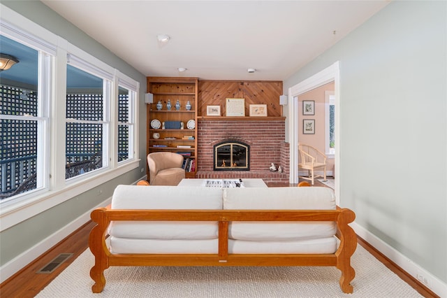 910 New Suffolk Ave, Mattituck, NY 11952 - living room with wood finished floors, baseboards, and a fireplace