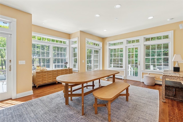 910 New Suffolk Ave, Mattituck, NY 11952 - dining area with wood finished floors, baseboard heating, a baseboard radiator, recessed lighting, and baseboards