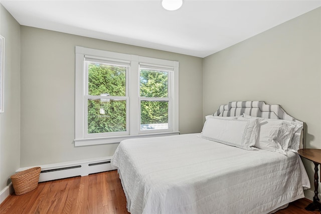910 New Suffolk Ave, Mattituck, NY 11952 - bedroom featuring baseboard heating and wood finished floors