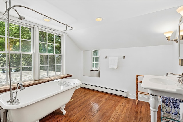 910 New Suffolk Ave, Mattituck, NY 11952 - bathroom with a baseboard radiator, lofted ceiling, a freestanding bath, wood finished floors, and recessed lighting