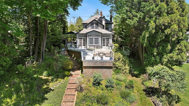 910 New Suffolk Ave, Mattituck, NY 11952 - rear view of property with a deck, stairs, and a chimney