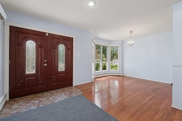 200-15 16th Ave, Bayside, NY 11360 - foyer featuring a chandelier, baseboard heating, baseboards, and wood finished floors