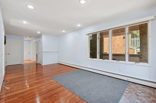 200-15 16th Ave, Bayside, NY 11360 - spare room featuring a baseboard radiator, recessed lighting, and wood finished floors