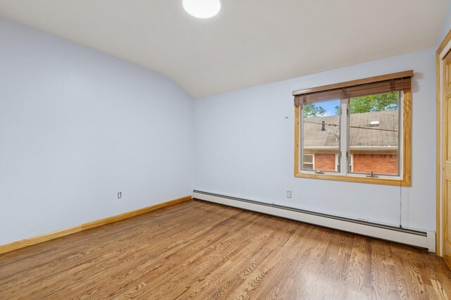 200-15 16th Ave, Bayside, NY 11360 - spare room featuring a baseboard radiator, lofted ceiling, light wood finished floors, and baseboards