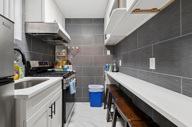 200-15 16th Ave, Bayside, NY 11360 - kitchen featuring gas range, light marble finish flooring, light countertops, extractor fan, and a kitchen bar