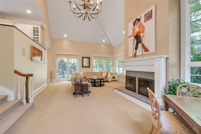 4 Pond Ln, Sands Point, NY 11050 - living area featuring high vaulted ceiling, carpet, healthy amount of natural light, a chandelier, and a glass covered fireplace