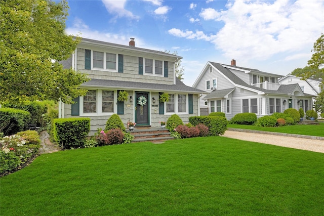 26 Adams Ave, Bayville, NY 11709 - view of front of house featuring a chimney and a front lawn