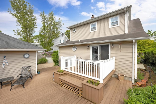 26 Adams Ave, Bayville, NY 11709 - rear view of property with a wooden deck and a chimney