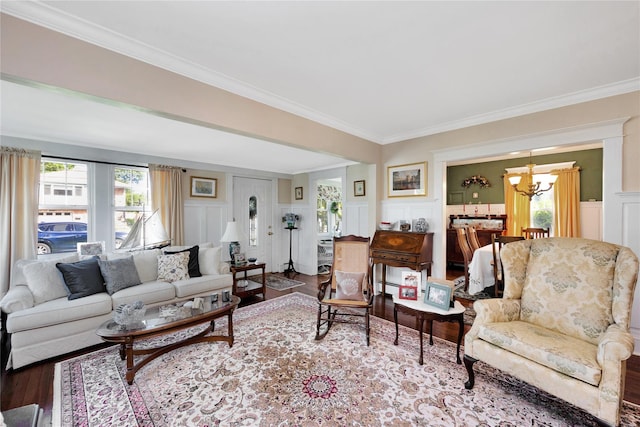 26 Adams Ave, Bayville, NY 11709 - living room with a decorative wall, wood finished floors, ornamental molding, and a chandelier