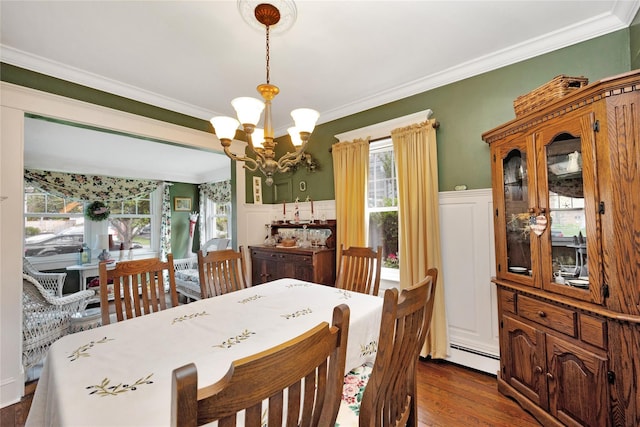 26 Adams Ave, Bayville, NY 11709 - dining room with a chandelier, ornamental molding, dark wood-style floors, and a baseboard heating unit