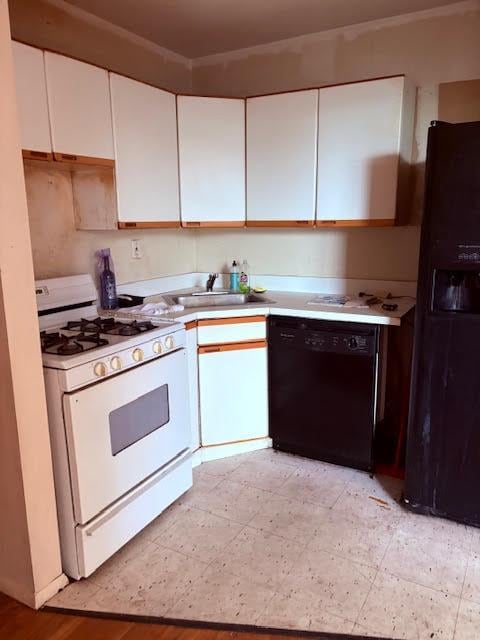 353 Ocean Ave Unit 4G, Brooklyn, NY 11226 - kitchen featuring black appliances, a sink, white cabinets, and light countertops