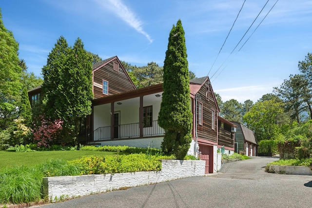 160 Longview Rd, Southampton, NY 11968 - view of front of property featuring a porch, a garage, and driveway