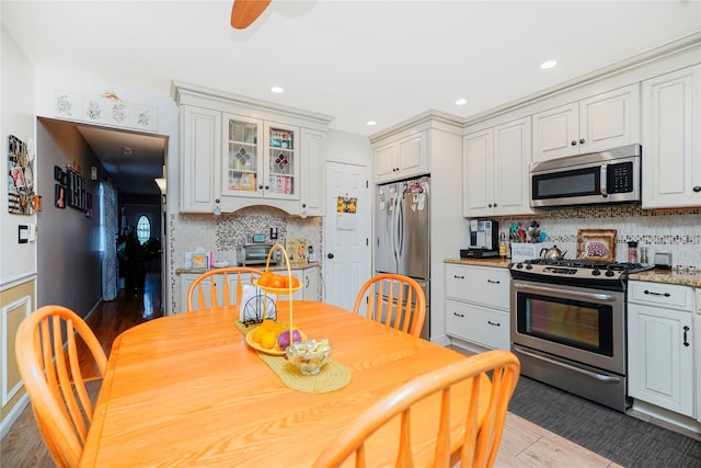 35 Futurity Pl, Staten Island, NY 10312 - kitchen with stainless steel appliances, wood finished floors, tasteful backsplash, glass insert cabinets, and recessed lighting