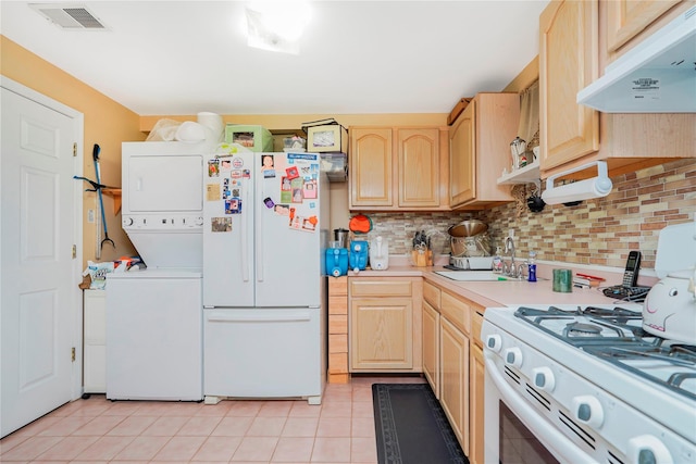 35 Futurity Pl, Staten Island, NY 10312 - kitchen with under cabinet range hood, white appliances, stacked washer and clothes dryer, light brown cabinets, and a sink