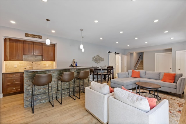 1 Majestic Rdg, Carmel, NY 10512 - living area featuring a barn door, light wood-type flooring, bar with sink, recessed lighting, and stairway