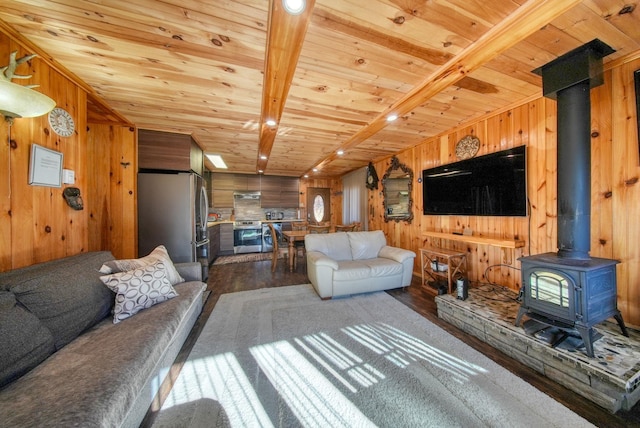 6 Medallion Rd, Kiamesha Lake, NY 12751 - living area featuring wood walls, wood finished floors, wooden ceiling, and a wood stove