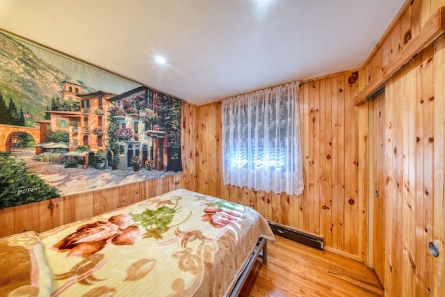 6 Medallion Rd, Kiamesha Lake, NY 12751 - bedroom with baseboard heating, wood finished floors, and wooden walls