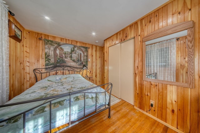 6 Medallion Rd, Kiamesha Lake, NY 12751 - bedroom with wood walls, a closet, and wood finished floors