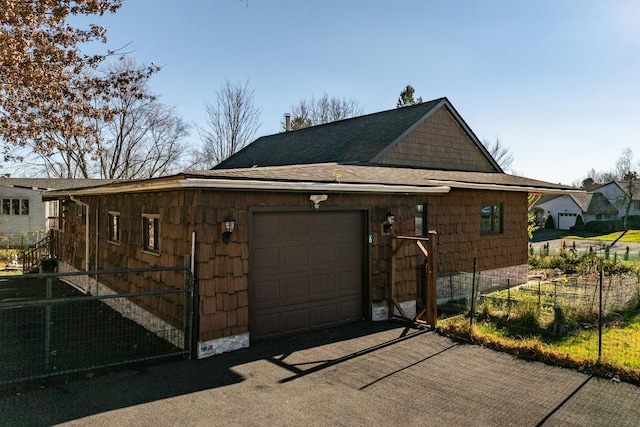 6 Medallion Rd, Kiamesha Lake, NY 12751 - view of home's exterior featuring an attached garage, asphalt driveway, and a shingled roof