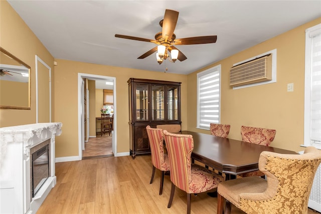 149-32 18th Ave, Whitestone, NY 11357 - dining area with a ceiling fan, light wood-style flooring, a wall mounted AC, baseboards, and a premium fireplace