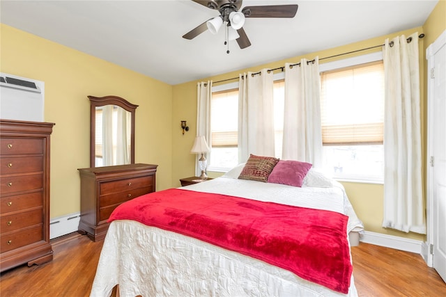 149-32 18th Ave, Whitestone, NY 11357 - bedroom with multiple windows, a baseboard radiator, and wood finished floors
