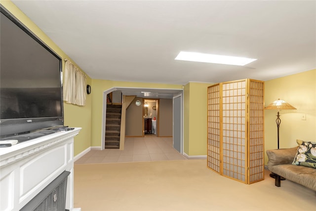149-32 18th Ave, Whitestone, NY 11357 - living area featuring baseboards, arched walkways, stairs, light colored carpet, and light tile patterned floors