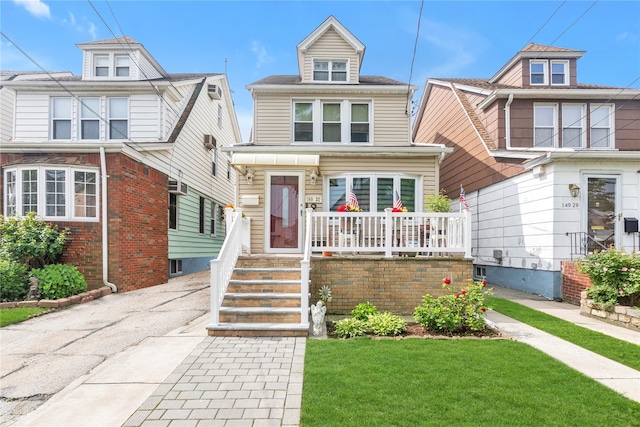 149-32 18th Ave, Whitestone, NY 11357 - american foursquare style home featuring covered porch and a front yard