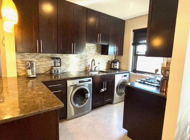 57-21 246th Cres Unit 1Fl, Douglaston, NY 11362 - kitchen with washer / dryer, a sink, backsplash, and dark stone countertops