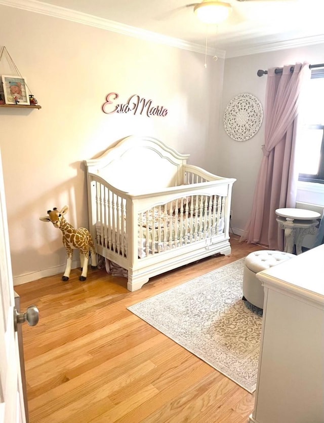 57-21 246th Cres Unit 1Fl, Douglaston, NY 11362 - bedroom with ornamental molding, wood finished floors, baseboards, and a crib