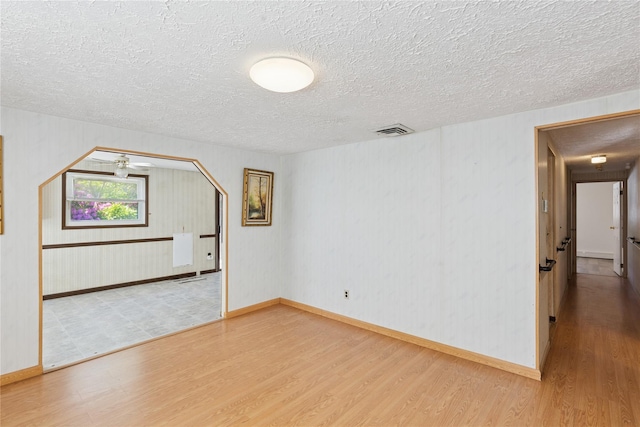 26 Beach Ave, Port Jefferson Station, NY 11776 - unfurnished room with wood finished floors, a textured ceiling, and baseboards