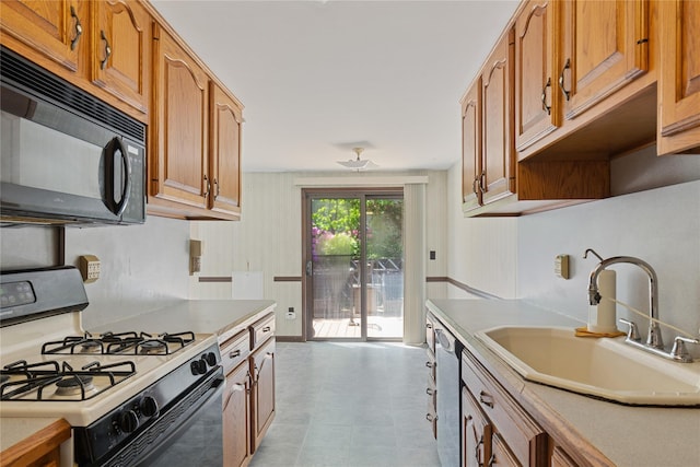 26 Beach Ave, Port Jefferson Station, NY 11776 - kitchen with gas range gas stove, black microwave, a sink, dishwasher, and light countertops