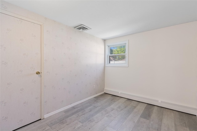 26 Beach Ave, Port Jefferson Station, NY 11776 - unfurnished room featuring a baseboard radiator, light wood-style flooring, wallpapered walls, and baseboards