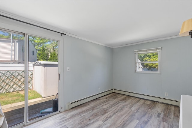 26 Beach Ave, Port Jefferson Station, NY 11776 - unfurnished room featuring wood finished floors, a baseboard heating unit, and crown molding