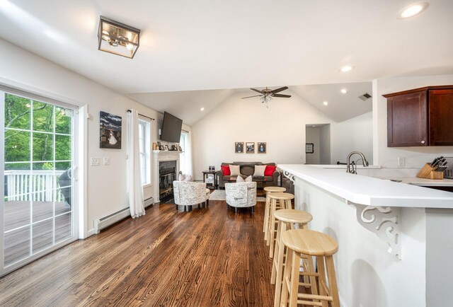 5692 Rte 82, Clinton Corners, NY 12514 - kitchen featuring a breakfast bar area, dark wood-style flooring, a peninsula, light countertops, and lofted ceiling