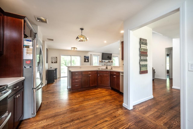 5692 Rte 82, Clinton Corners, NY 12514 - kitchen with stainless steel appliances, a sink, dark wood-style floors, light countertops, and a peninsula