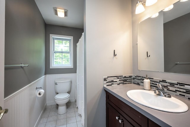 5692 Rte 82, Clinton Corners, NY 12514 - full bath featuring vanity, a wainscoted wall, toilet, tile patterned flooring, and tasteful backsplash