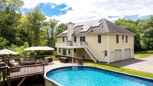 5692 Rte 82, Clinton Corners, NY 12514 - rear view of property featuring outdoor lounge area, a wooden deck, roof mounted solar panels, and an outdoor pool