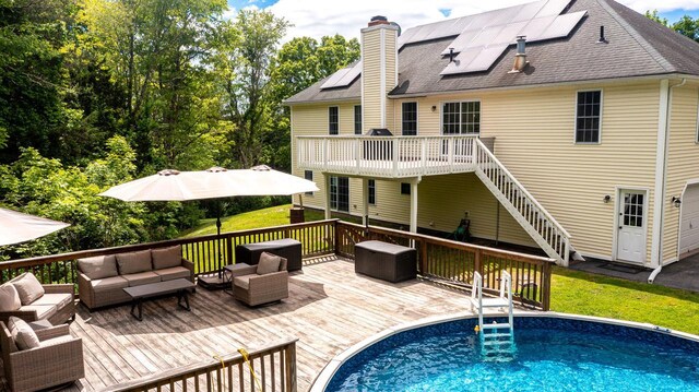 5692 Rte 82, Clinton Corners, NY 12514 - rear view of property with an outdoor living space, a deck, roof mounted solar panels, an outdoor pool, and a chimney