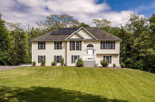 5692 Rte 82, Clinton Corners, NY 12514 - bi-level home featuring roof mounted solar panels, a front yard, and view of scattered trees