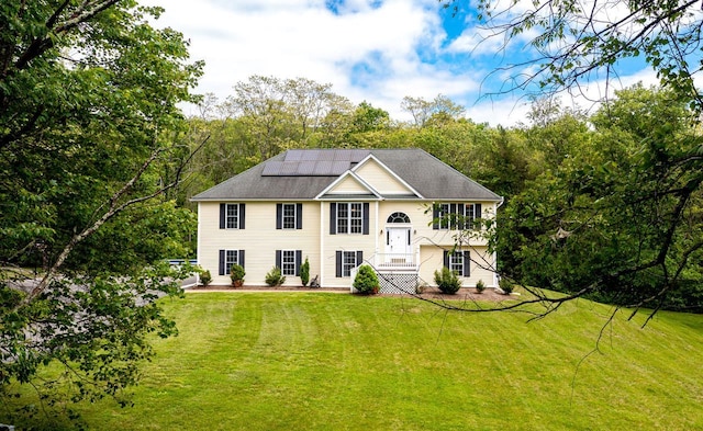 5692 Rte 82, Clinton Corners, NY 12514 - raised ranch with solar panels, a front yard, and view of wooded area