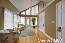 738 Shore Walk, Lindenhurst, NY 11757 - entryway featuring wood finished floors, baseboards, and high vaulted ceiling