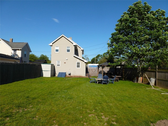 66 Evergreen Ave, Patchogue, NY 11772 - rear view of property with a gazebo and a chimney