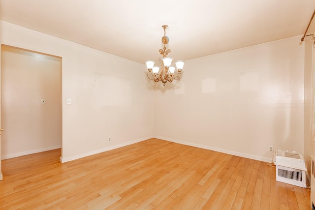 30 Jean Dr, North Babylon, NY 11703 - empty room with a chandelier, light wood-style flooring, and baseboards