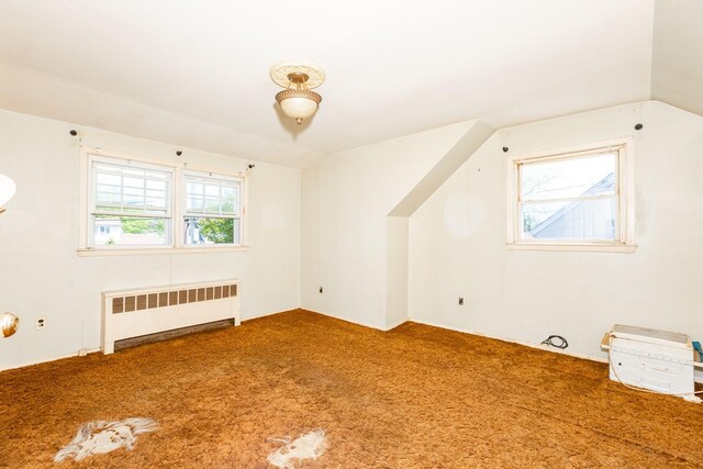 30 Jean Dr, North Babylon, NY 11703 - additional living space with radiator, carpet floors, and lofted ceiling