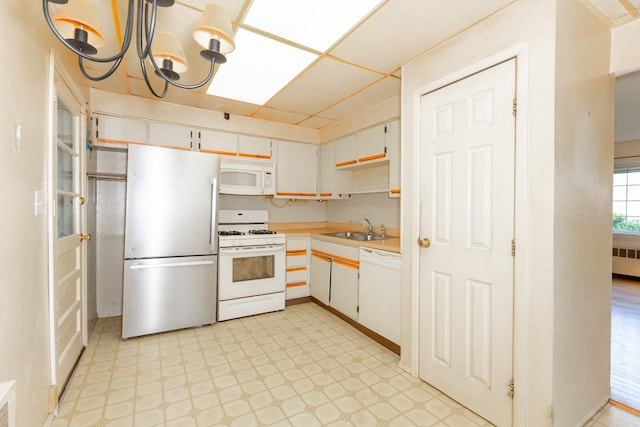 30 Jean Dr, North Babylon, NY 11703 - kitchen featuring white appliances, a sink, radiator heating unit, light countertops, and light floors