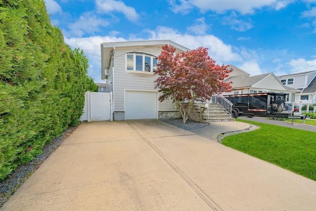 15 W Granada Ave, Lindenhurst, NY 11757 - view of front of house featuring an attached garage, driveway, and a gate
