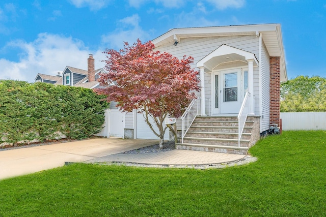 15 W Granada Ave, Lindenhurst, NY 11757 - view of front of property featuring driveway and a garage