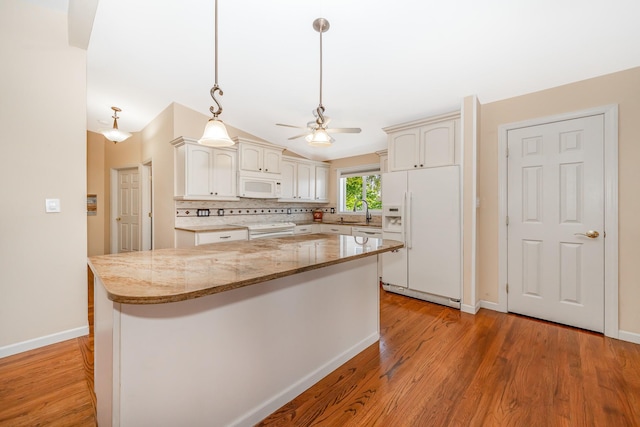 15 W Granada Ave, Lindenhurst, NY 11757 - kitchen with white appliances, ceiling fan, a kitchen island, light wood-style flooring, and hanging light fixtures